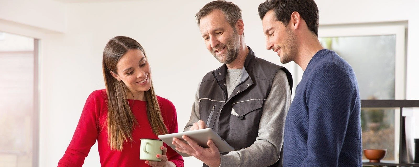 Couple with installer in kitchen